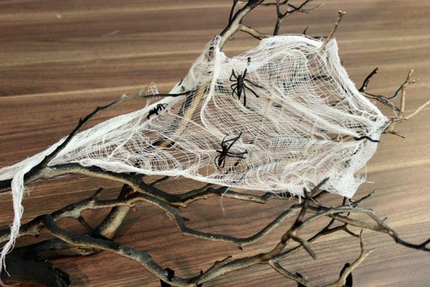 Make This Hanging Bat Centerpiece For Your Halloween Party! glue felt fake fur spray paint branch easy budget8