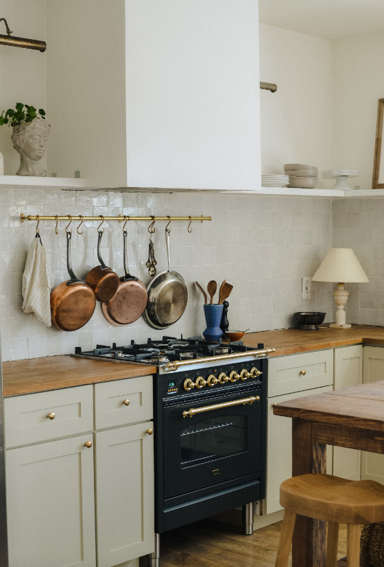 Rustic style kitchen with hanging copper pots.